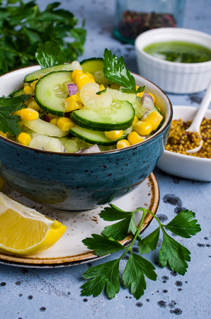 Salad with raw vegetables and corn in a plate on the table. Selective focus.の写真素材