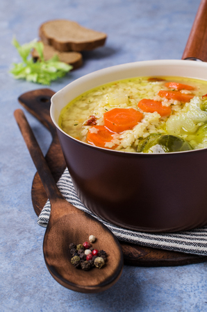 Thick clear soup with pasta and vegetables in dish. Selective focus.の写真素材