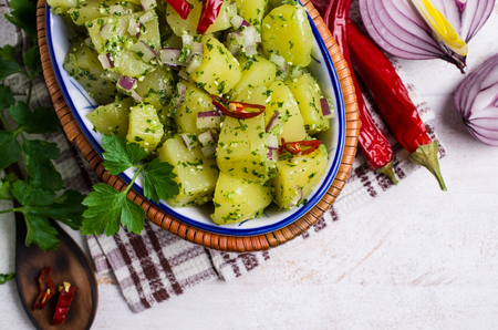 Boiled potato slices with green sauce and spices. Selective focus.の写真素材