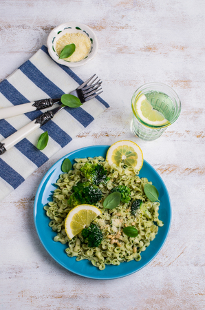 Traditional pasta tripoline with pesto and broccoli in a plate on the table. Selective focus.の写真素材