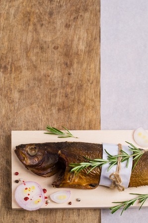 Smoked whole fish with spices on wooden background. Selective focus.の写真素材