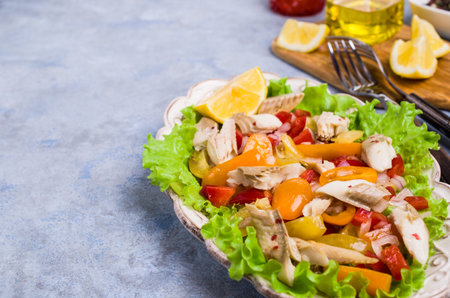 Fish fillet with raw vegetables and lemon in a dish on the table. Selective focus.の写真素材