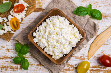 Curd cheese in a dish with toast, tomatoes and Basil. Selective focus.の写真素材