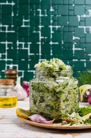 Salad with raw vegetables and dill in a dish on the table. Selective focus.の写真素材