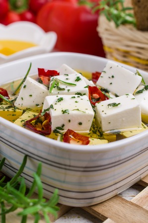 Traditional white cheese slices in oil with spices. Selective focus.の写真素材