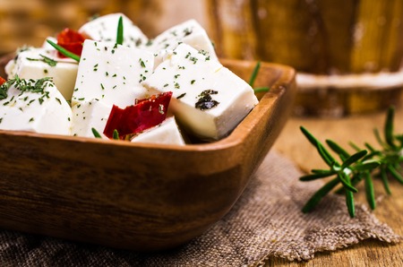 Traditional white cheese slices in oil with spices. Selective focus.の写真素材