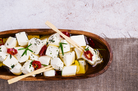 Traditional white cheese slices in oil with spices. Selective focus.の写真素材