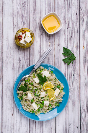 Salad of crushed cereals with vegetables and cheese on a wooden background. Selective focus.の写真素材