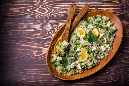 Salad of crushed cereals with vegetables and cheese on a wooden background. Selective focus.の写真素材