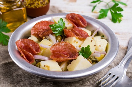 Traditional potato salad with salami and spices. Selective focus.の写真素材