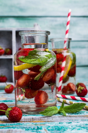 Cold transparent drink with fruit in the glass on the table. Selective focus.の写真素材