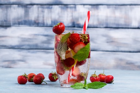 Cold transparent drink with fruit in the glass on the table. Selective focus.の写真素材
