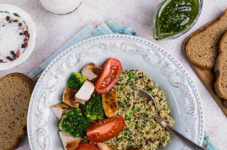 Fried chicken breast slices with quinoa and vegetables. Selective focus.の写真素材
