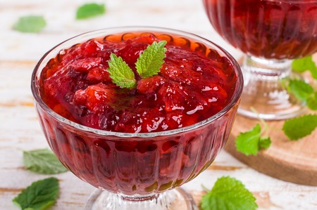 Sliced red strawberries in a thick sweet syrup. Selective focus.の写真素材