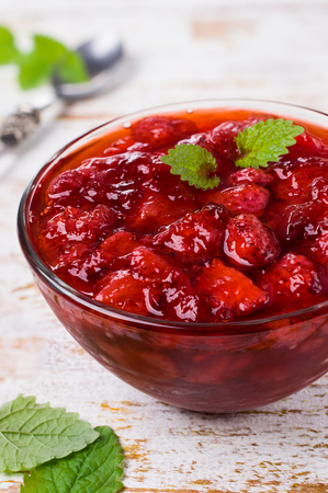 Sliced red strawberries in a thick sweet syrup. Selective focus.の写真素材