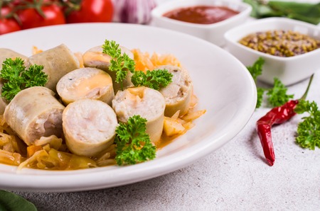 Slices of natural sausages with cheese and stewed cabbage. Selective focus.の写真素材