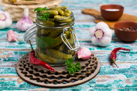 Pickled cucumbers with spices and parsley on a wooden background. Selective focus.の写真素材