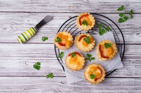 Tartlets with vegetables and cheese on wooden background. Selective focus.の写真素材