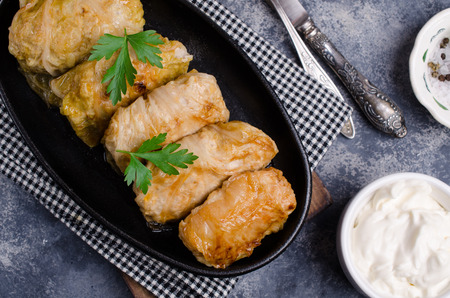 Fried stuffed cabbage in a frying pan on a stone background. Selective focus.の写真素材