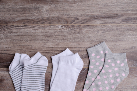 Short clean knitted socks on wooden background. Selective focus.の写真素材