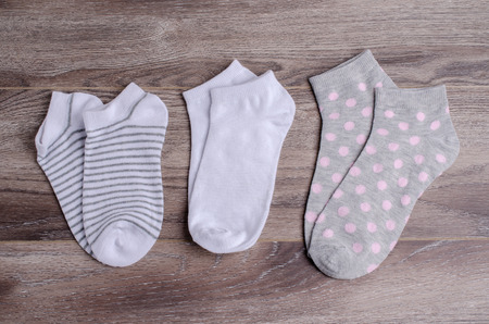 Short clean knitted socks on wooden background. Selective focus.の写真素材