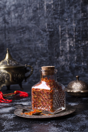 Traditional dry saffron spice on dark slate background. Selective focus.の写真素材