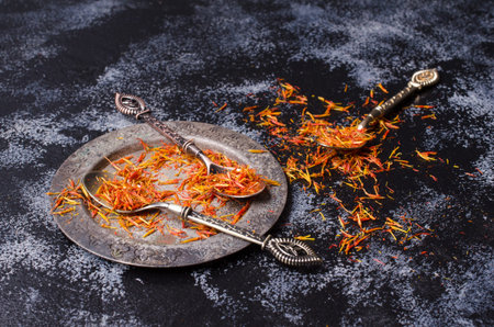 Traditional dry saffron spice on dark slate background. Selective focus.の写真素材