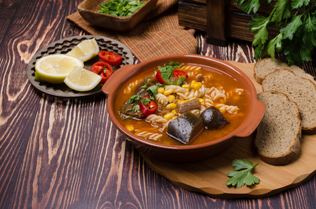 Thick red soup with pasta, minced meat and vegetables. Selective focus.の写真素材