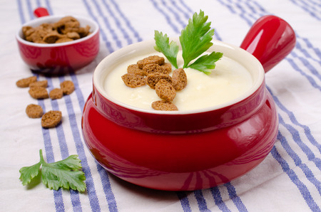 Thick vegetable cream soup with croutons on a textile background. Selective focus.の写真素材