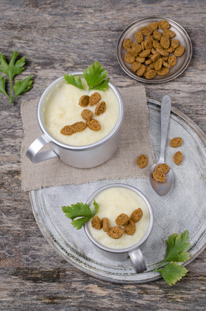 Thick vegetable cream soup with croutons on wooden background. Selective focus.の写真素材