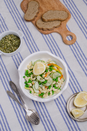Salad with pasta and fresh vegetables on a textile background. Selective focus.の写真素材