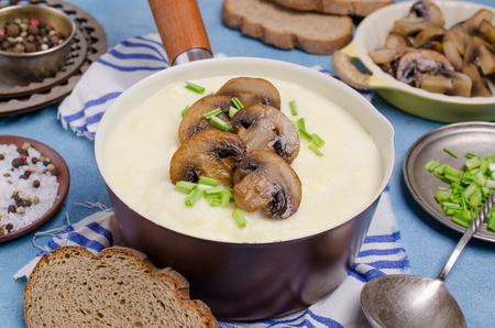 Thick vegetable cream soup with mushrooms on a slate background. Selective focus.の写真素材