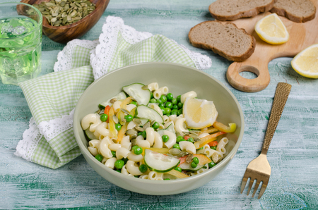 Salad with pasta and fresh vegetables on wooden background. Selective focus.の写真素材