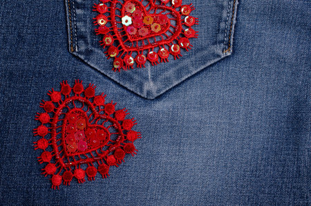 Lace decorative heart on blue denim background. Selective focus.