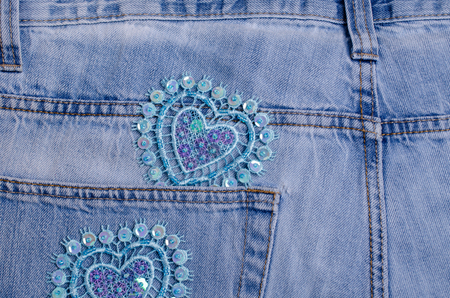 Lace decorative heart on blue denim background. Selective focus.の写真素材