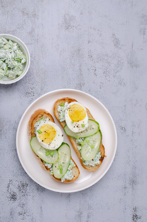 Open sandwich with vegetables and eggs on wooden background. Selective focus.の写真素材