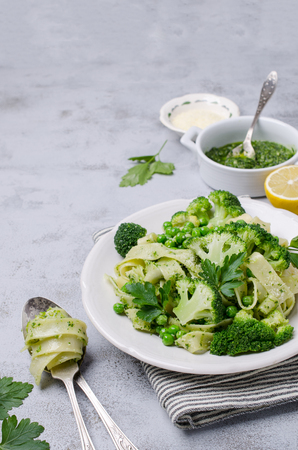 Traditional Italian pasta with green vegetables and pesto sauce. Selective focus.の写真素材