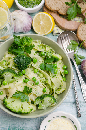 Traditional Italian pasta with green vegetables and pesto sauce. Selective focus.の写真素材