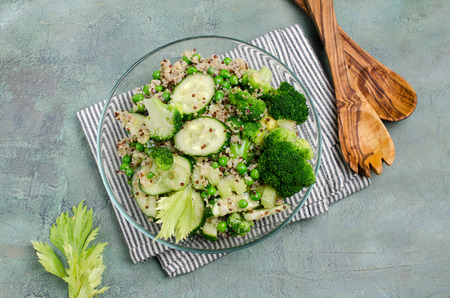 Salad with quinoa and slices of fresh green vegetables in a bowl on the table. Selective focus.の写真素材