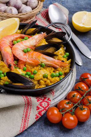 Traditional paella with seafood and meat slices. Selective focus.の写真素材