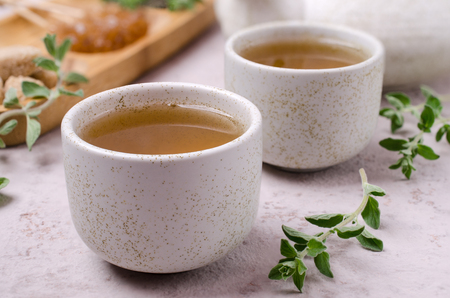 Traditional green herbal tea with oregano and sugar. Selective focus.の写真素材