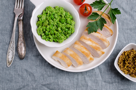 Fried chicken breast with green vegetable puree. Selective focus.の写真素材