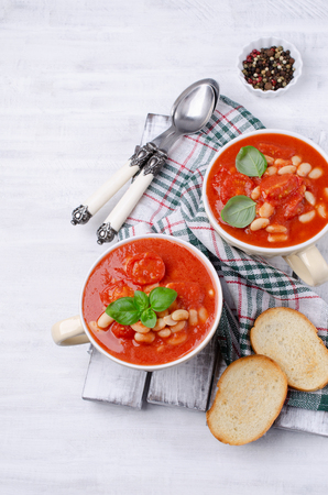 Thick tomato soup with beans in a bowl on the table. Selective focus.の写真素材