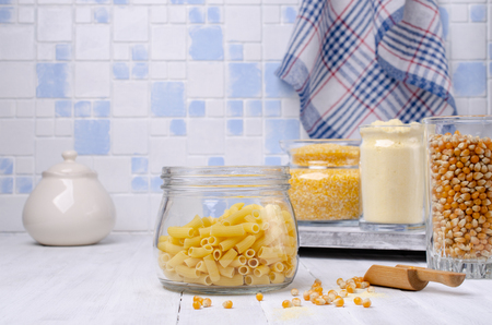 Assorted corn products in a glass jar on a wooden table. Selective focus.の写真素材