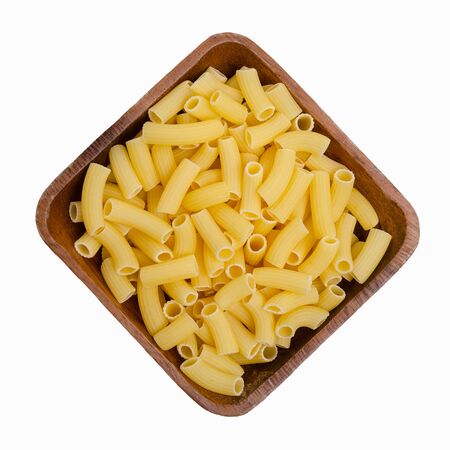 Dry pasta in a bowl on a white background. The concept of healthy eating.の写真素材