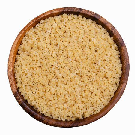 Dry pasta in a bowl on a white background. The concept of healthy eating.の写真素材