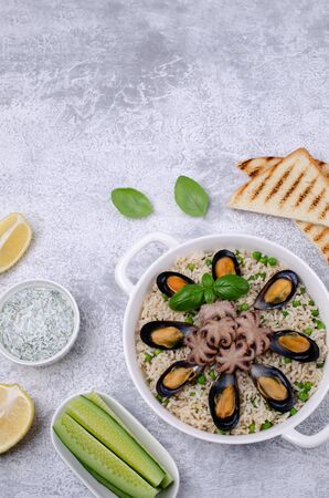 Seafood with brown rice and green peas in the dish. Selective focus.の写真素材