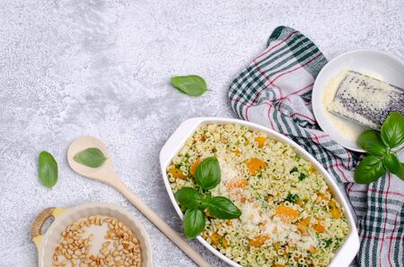 Traditional pasta with pumpkin, pesto and cheese in a dish. Selective focus.の写真素材