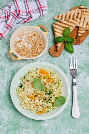 Traditional pasta with pumpkin, pesto and cheese in a dish. Selective focus.の写真素材