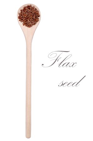 Dry brown flax seeds in wooden utensils on white background.の写真素材